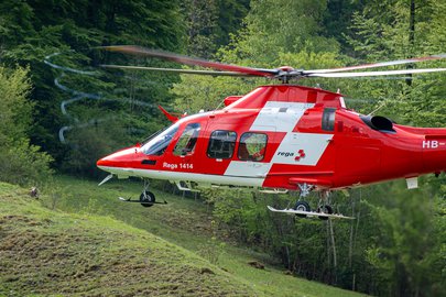 An Agusta Westland Da Vinci helicopter in front of a forest