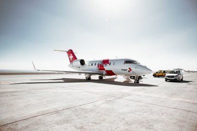 A Rega Challenger 650 ambulance jet parked on the tarmac, ready for a repatriation flight.